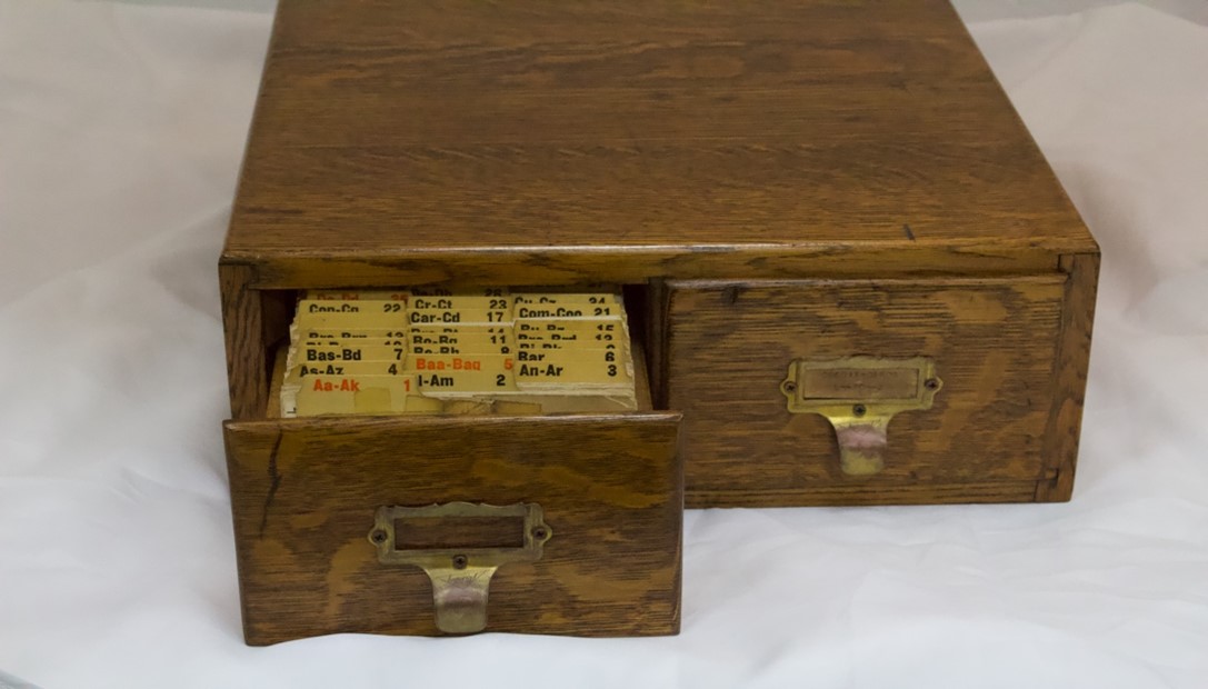  Wooden file box with one draw open to show files.