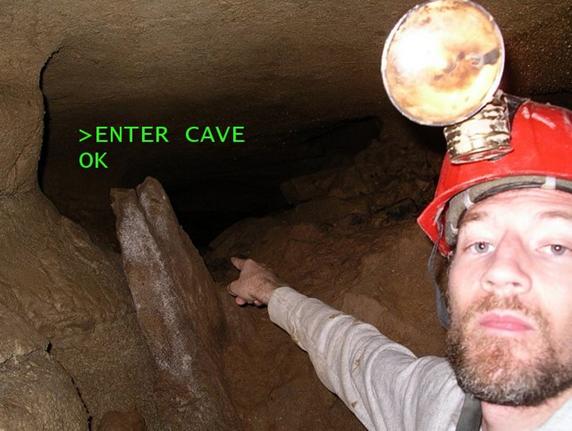 Image of a "wild cave" showing photo of the author pointing into a dark
						cave tunnel with command-line style words "ENTER CAVE" and "OK" superimposed